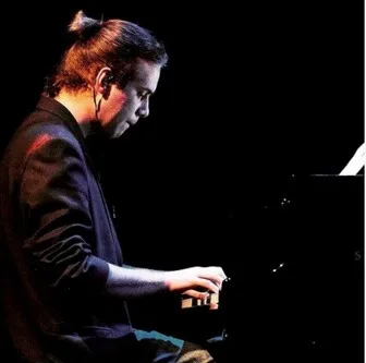 Composer Antoni Wojnar at the piano
