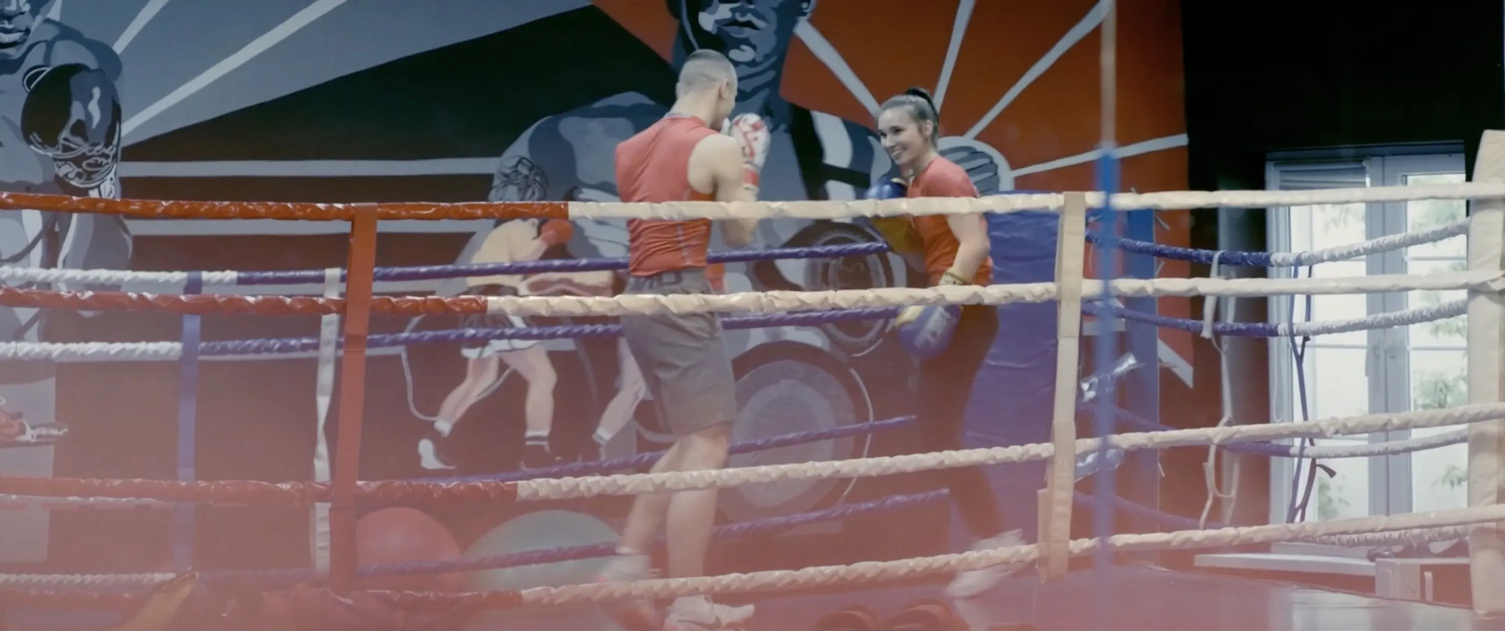 Olimpia Konczalska smiles as she spars with Łukasz in a boxing ring